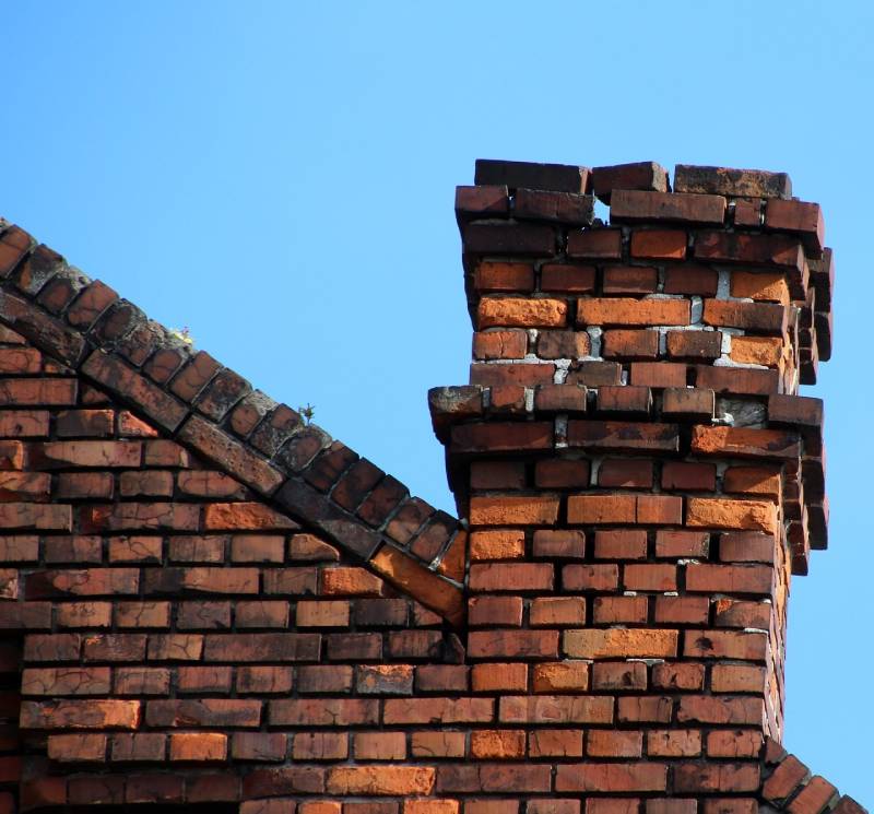 Signs Your Sterling Home Needs a Chimney Inspection Damaged chimney on an Sterling home showing cracks and missing mortar